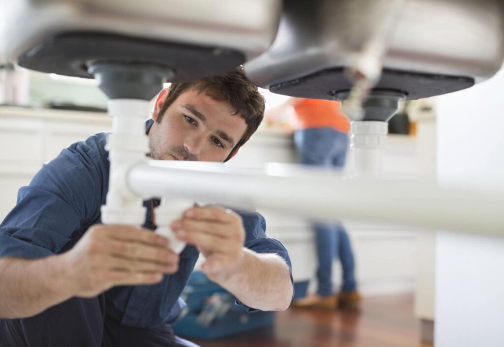 federal way plumbing service technician fixing kitched pipes